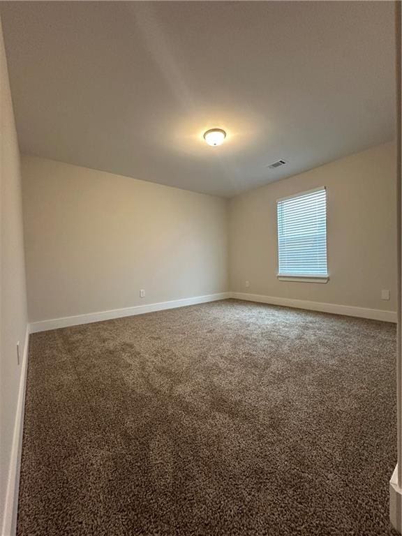 carpeted empty room with baseboards and visible vents