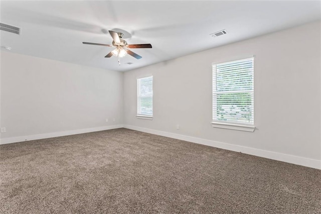 carpeted empty room featuring a ceiling fan, baseboards, and visible vents