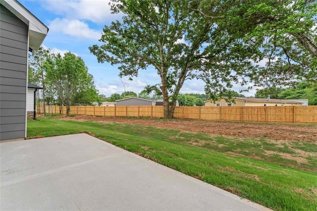 view of yard featuring fence and a patio area