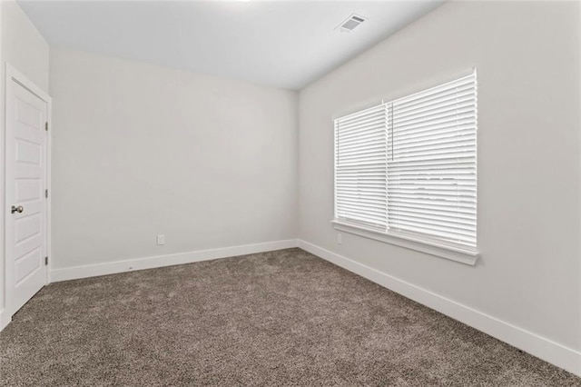 unfurnished room with visible vents, carpet flooring, and baseboards