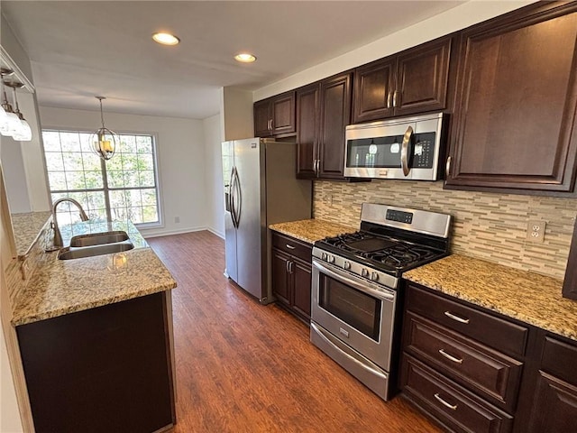 kitchen featuring decorative backsplash, dark brown cabinets, stainless steel appliances, and dark wood-style flooring