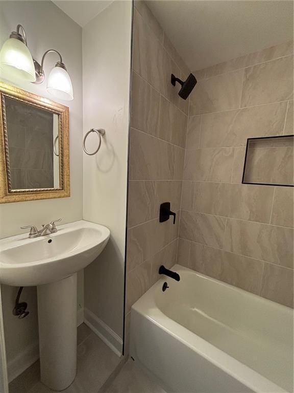 full bath with tile patterned flooring, bathing tub / shower combination, baseboards, and a sink