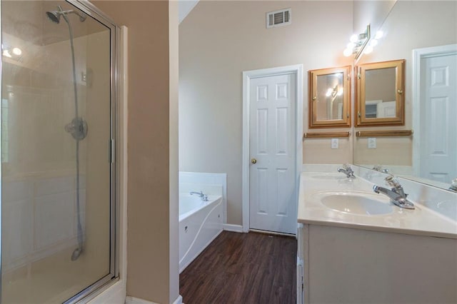 1615 Burnt Oak Way, Dacula, GA 30019 - bathroom featuring a stall shower, a garden tub, double vanity, and wood finished floors