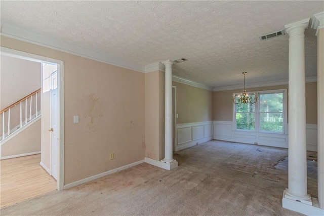 1615 Burnt Oak Way, Dacula, GA 30019 - carpeted empty room featuring decorative columns, ornamental molding, stairway, a textured ceiling, and wainscoting