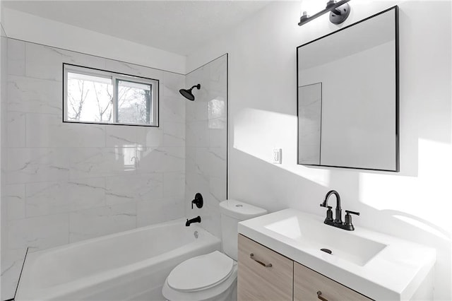 full bathroom featuring toilet, tiled shower / bath, and vanity