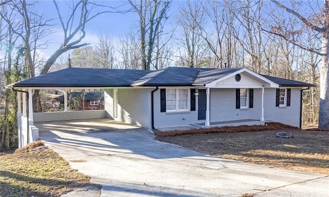 ranch-style home with covered porch and a carport