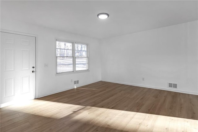 unfurnished room featuring hardwood / wood-style flooring