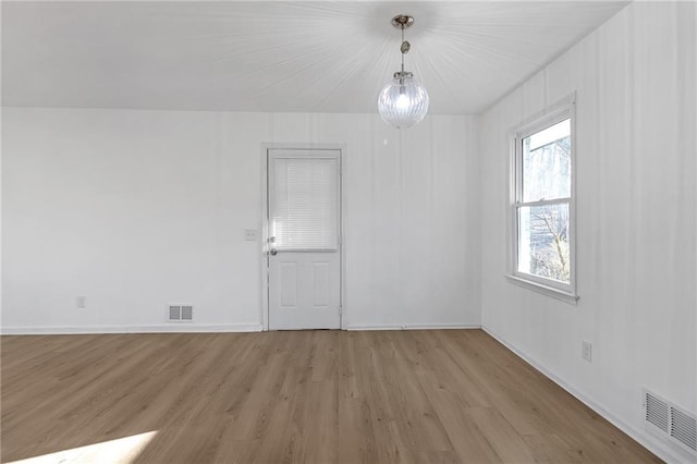 spare room with light hardwood / wood-style floors