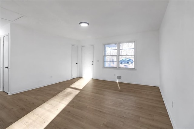 spare room with dark hardwood / wood-style floors