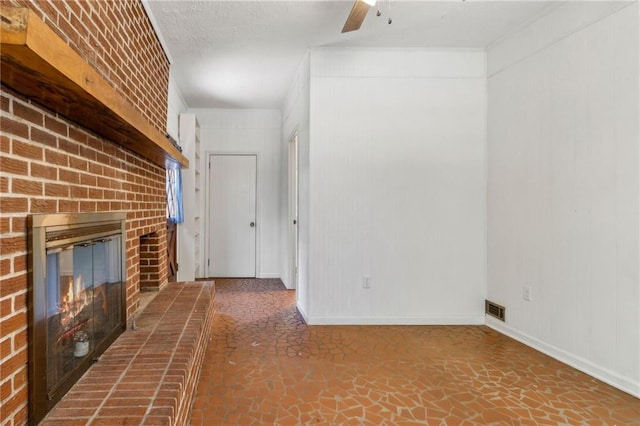 128 Mountain View Dr, Gainesville, GA 30501 - unfurnished living room with a brick fireplace, ceiling fan, baseboards, and stone finish floors