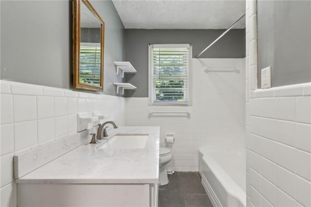 128 Mountain View Dr, Gainesville, GA 30501 - full bathroom featuring tile walls, toilet, tile patterned floors, vanity, and tub / shower combination