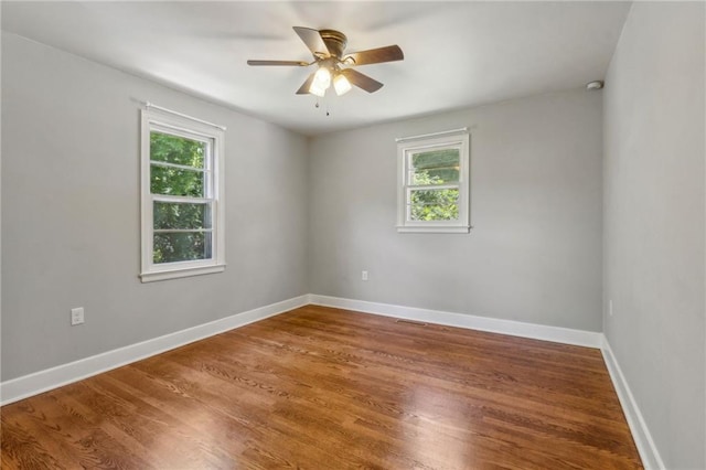 128 Mountain View Dr, Gainesville, GA 30501 - empty room featuring healthy amount of natural light, a ceiling fan, wood finished floors, and baseboards