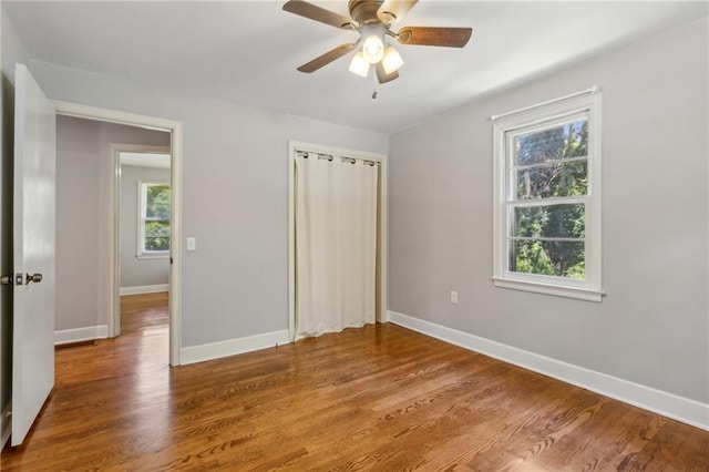 128 Mountain View Dr, Gainesville, GA 30501 - unfurnished bedroom with multiple windows, baseboards, a closet, and wood finished floors