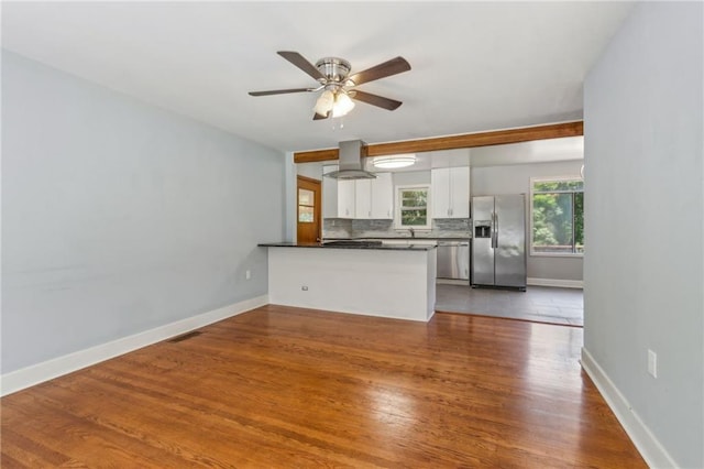 128 Mountain View Dr, Gainesville, GA 30501 - unfurnished living room featuring wood finished floors, ceiling fan, baseboards, and a sink