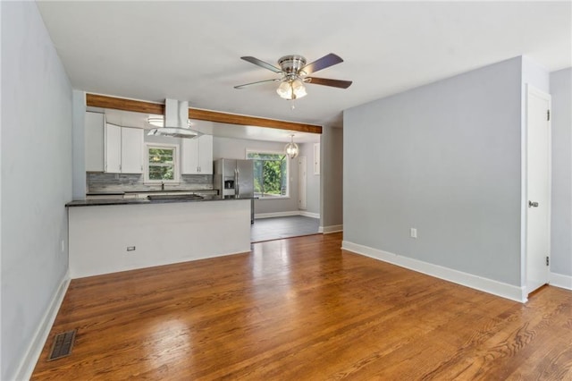 128 Mountain View Dr, Gainesville, GA 30501 - kitchen featuring dark countertops, a ceiling fan, white cabinets, a peninsula, and decorative backsplash
