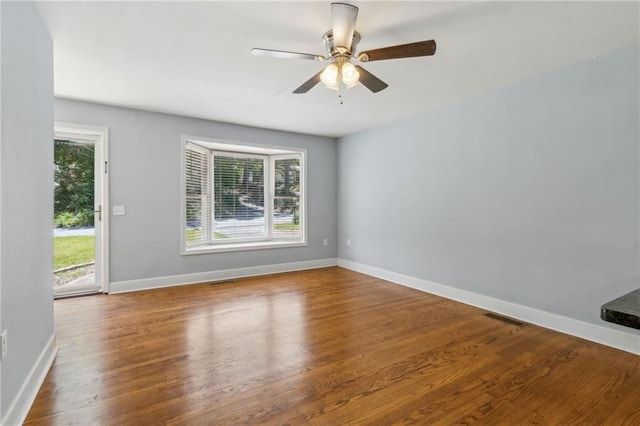 128 Mountain View Dr, Gainesville, GA 30501 - empty room with wood finished floors, baseboards, and a ceiling fan
