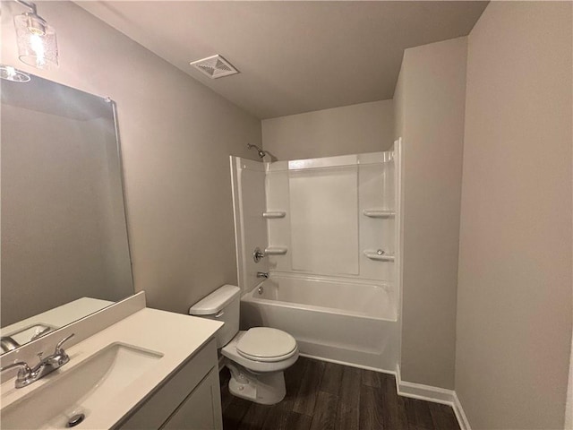 full bathroom with hardwood / wood-style flooring, shower / tub combination, vanity, and toilet