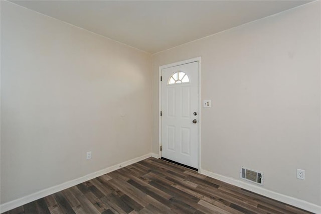 entrance foyer with baseboards, visible vents, and dark wood-type flooring