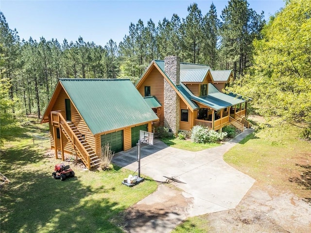 log home with a front lawn and covered porch