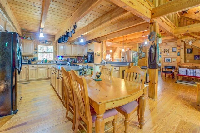 dining room featuring wood walls, beamed ceiling, wood ceiling, and light wood-type flooring