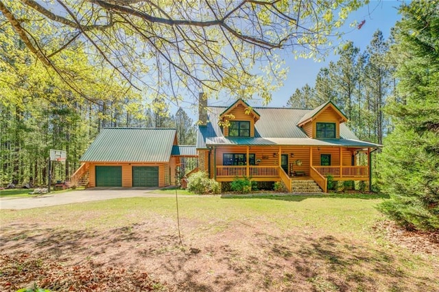 log-style house with covered porch, a garage, and a front lawn