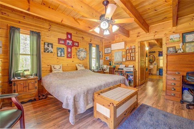 bedroom with wood ceiling, ceiling fan, wooden walls, hardwood / wood-style flooring, and beamed ceiling