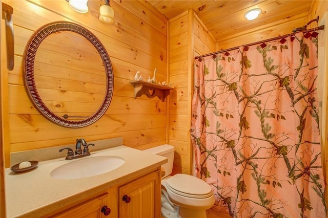 bathroom with vanity, wooden walls, toilet, walk in shower, and wood ceiling