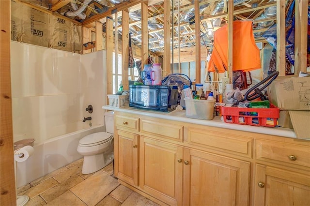 bathroom featuring tile patterned flooring, shower / bath combination with curtain, and toilet