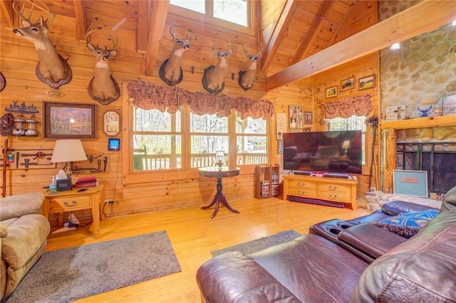 living room featuring beamed ceiling, wood walls, wooden ceiling, and hardwood / wood-style flooring