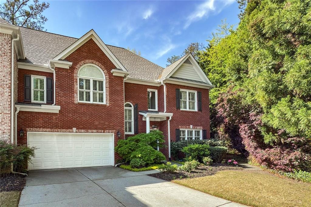 104 Glentown Way, Sandy Springs, GA 30328 - view of front of house with a garage, a shingled roof, driveway, and brick siding