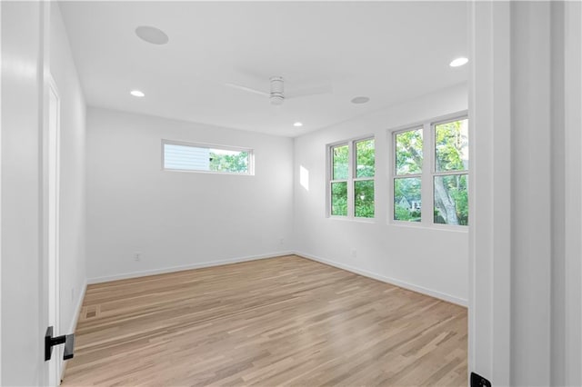 spare room featuring light hardwood / wood-style flooring and ceiling fan