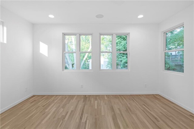 unfurnished room with light hardwood / wood-style floors