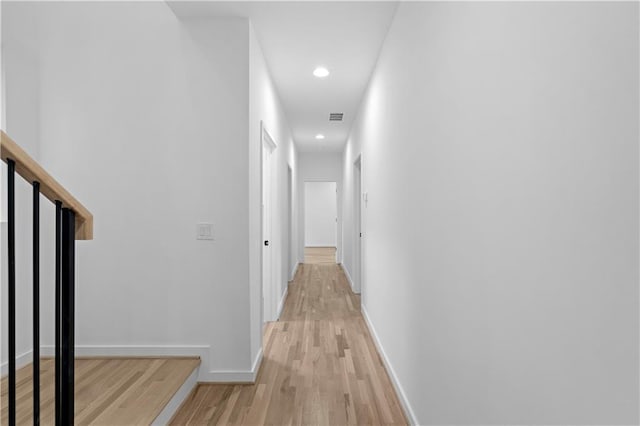 hallway with light hardwood / wood-style floors