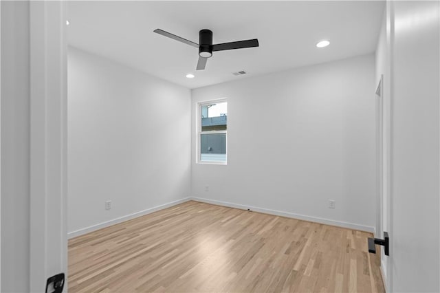 spare room with ceiling fan and light wood-type flooring