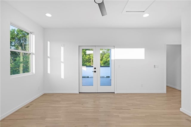 spare room with ceiling fan, french doors, and light hardwood / wood-style floors