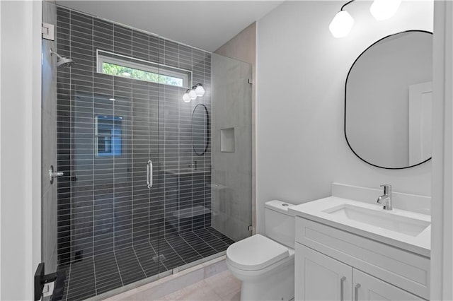 bathroom with tile patterned flooring, vanity, toilet, and an enclosed shower