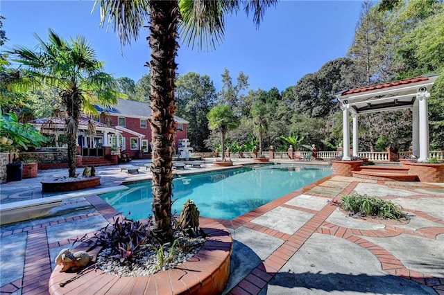 outdoor pool with a patio area