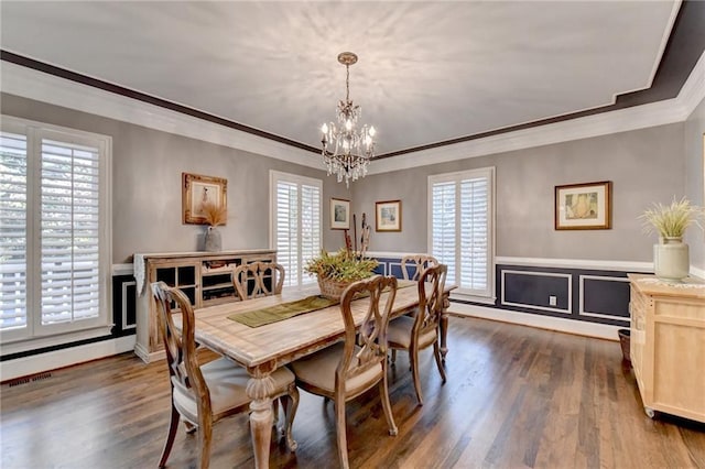 dining space with a healthy amount of sunlight, crown molding, and dark hardwood / wood-style floors