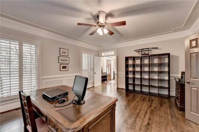 home office featuring ceiling fan, dark wood-type flooring, crown molding, and a healthy amount of sunlight