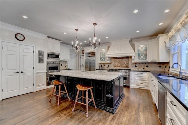 kitchen featuring premium range hood, premium appliances, and white cabinetry