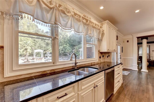 kitchen with custom exhaust hood, white cabinets, light stone countertops, and stainless steel appliances