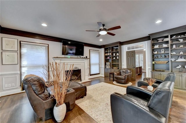 living room with decorative columns and ornamental molding