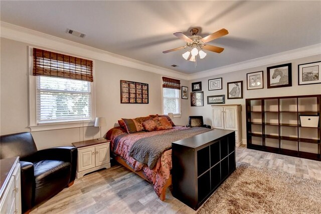 bedroom with wood-type flooring, ceiling fan, and ornamental molding