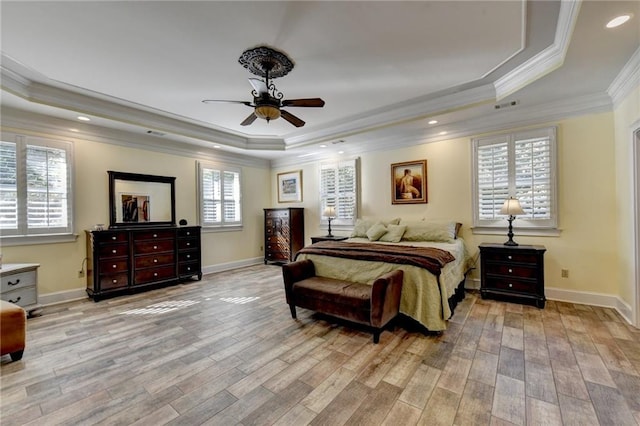 bedroom with ensuite bathroom, a spacious closet, a closet, ceiling fan, and a tray ceiling