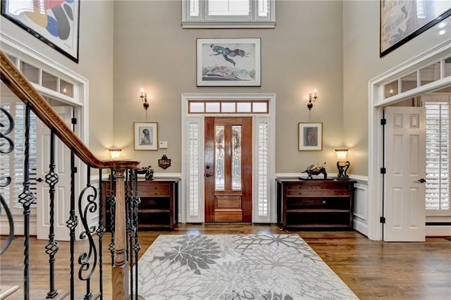 stairs featuring wood-type flooring and ornamental molding