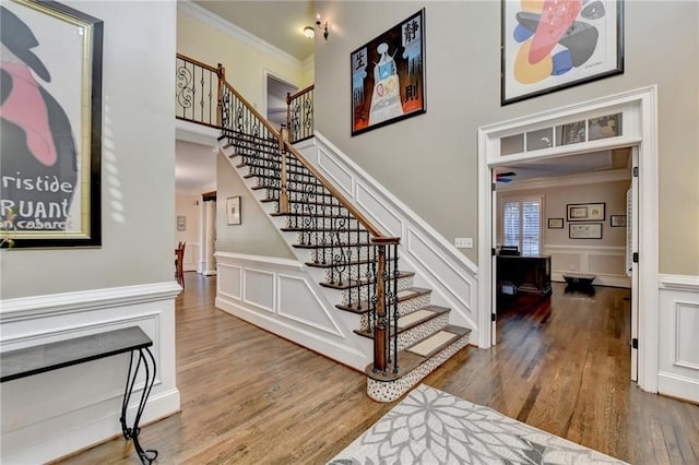 dining space with wood-type flooring, a chandelier, and ornamental molding