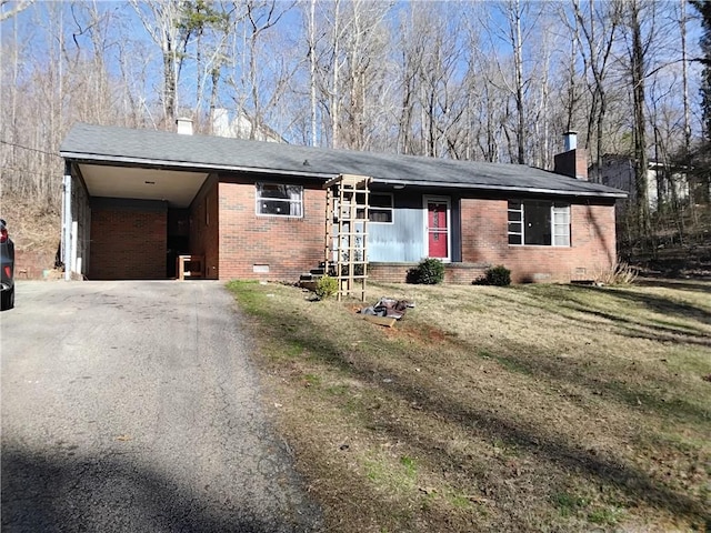 ranch-style home featuring driveway, brick siding, crawl space, and a chimney