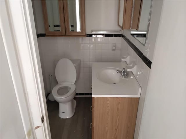 4076 Fairmont St, Gainesville, GA 30506 - bathroom with toilet, wood finished floors, tile walls, and vanity
