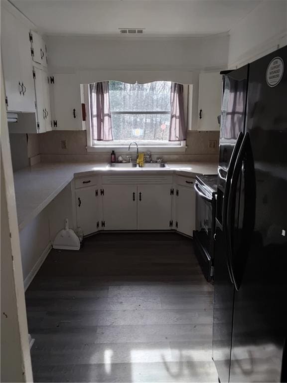 4076 Fairmont St, Gainesville, GA 30506 - kitchen with a sink, electric stove, white cabinetry, and black fridge
