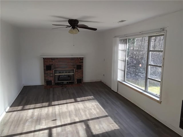 4076 Fairmont St, Gainesville, GA 30506 - unfurnished living room with ceiling fan, a brick fireplace, dark wood finished floors, and visible vents